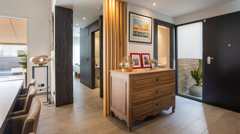 A pine dresser in an open-plan hallway in a modern home