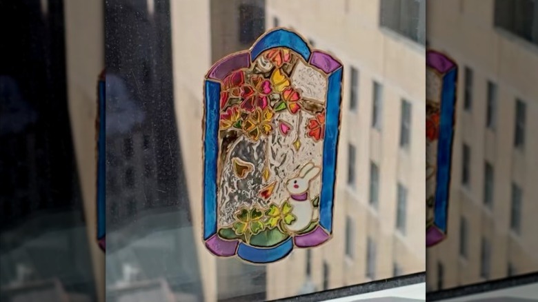 A faux stained glass window decal made using transparent cling film and glass paint.