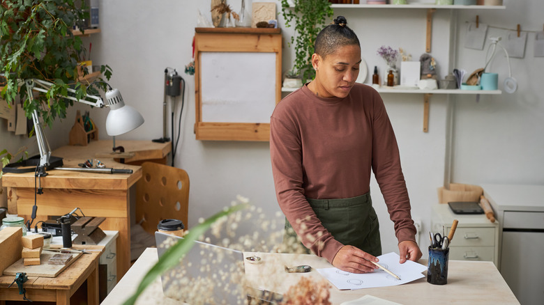 A person working in their craft room.