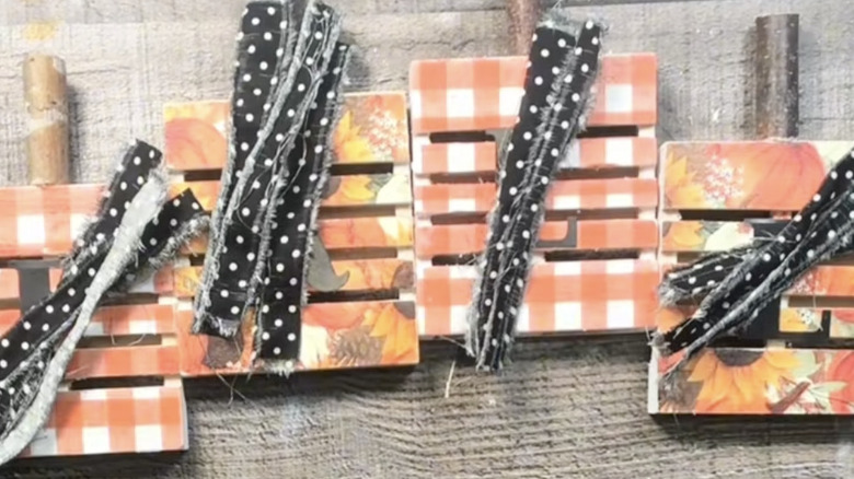 Tabletop pumpkin décor made from mini wood pallets from Dollar Tree.