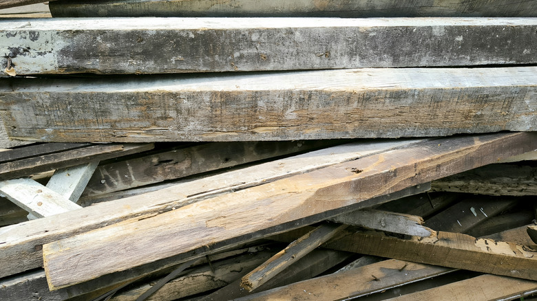 Pile of aged wooden beams with splinters and imperfections