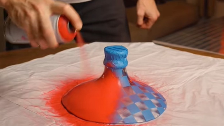 Person spray painting DIY pendant light