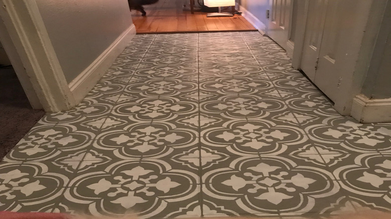 A hallway with a stenciled tile floor