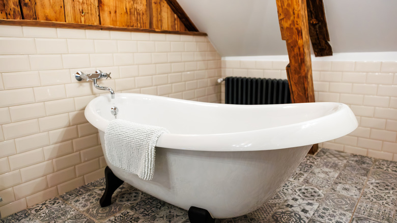 stand alone bath in bathroom with slanted ceiling
