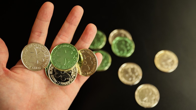 Hand holding fake gold coins