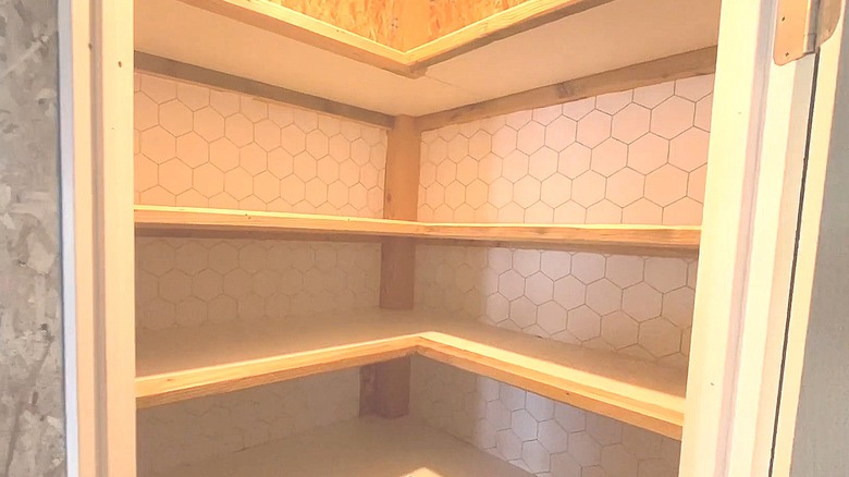 Pantry with geometric peel-and-stick wallpaper on the back wall