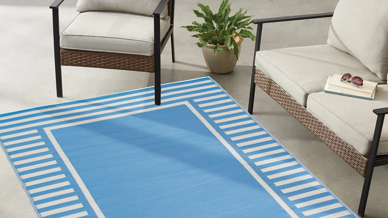 Blue and white striped outdoor area rug on a front porch