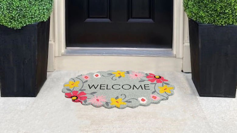 Floral scalloped doormat in front of black front door