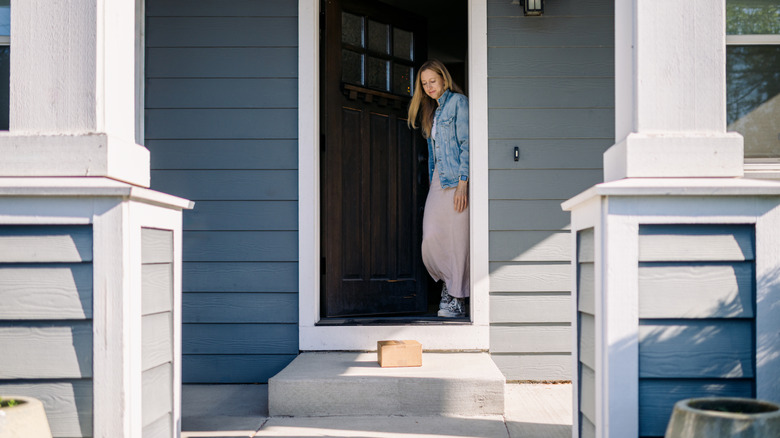 Woman getting a package off of her front porch