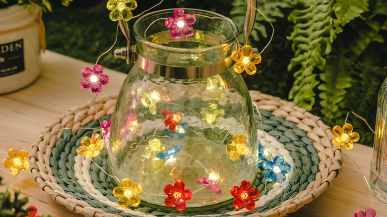 Outdoor lantern wrapped in floral fairy lights