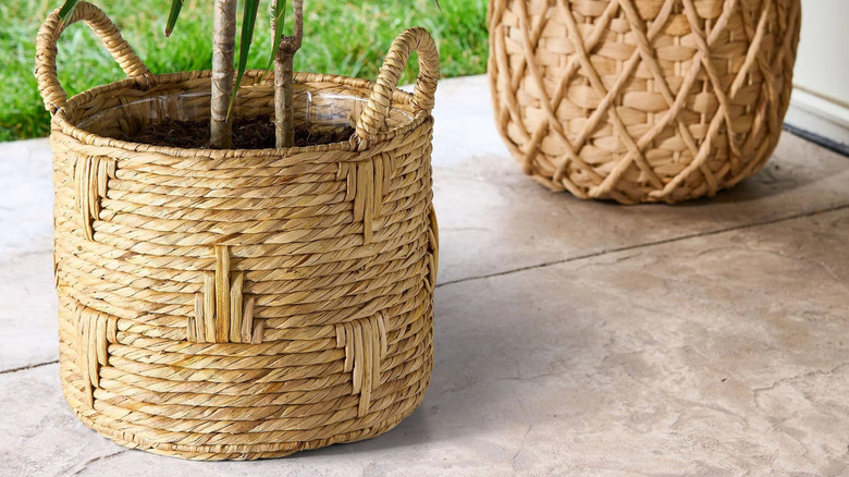 A basket planter sitting on a concrete patio