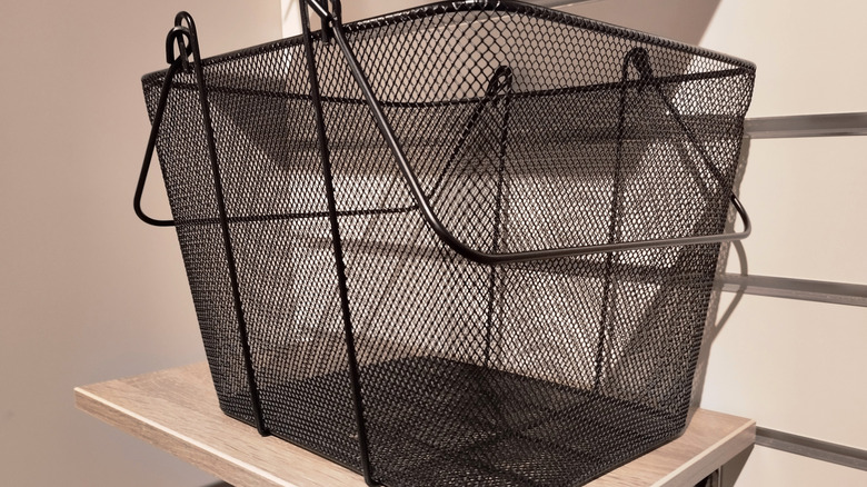 Black wire storage basket on a shelf