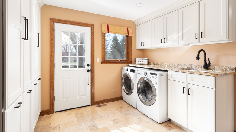 laundry room with white cabinets