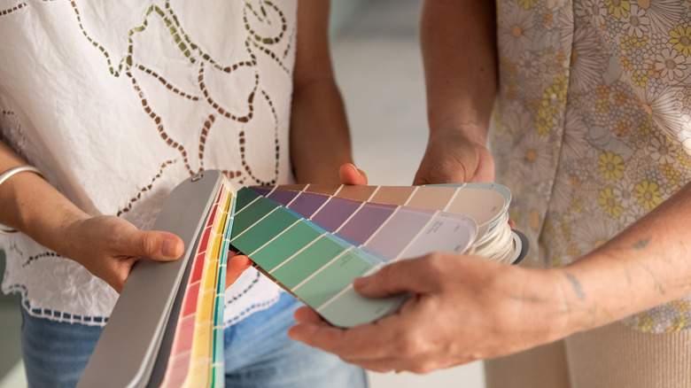Couple looking through a selection of paint swatches