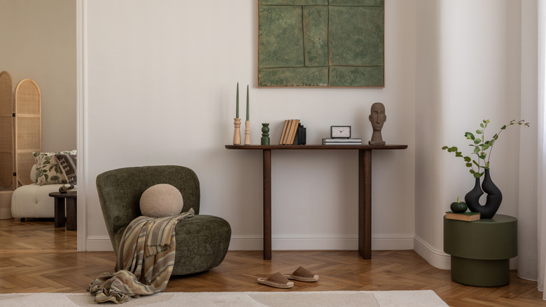 minamalist home with moss green chair and table
