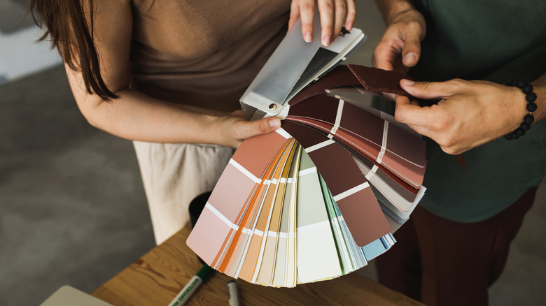Couple holding paint sample cards