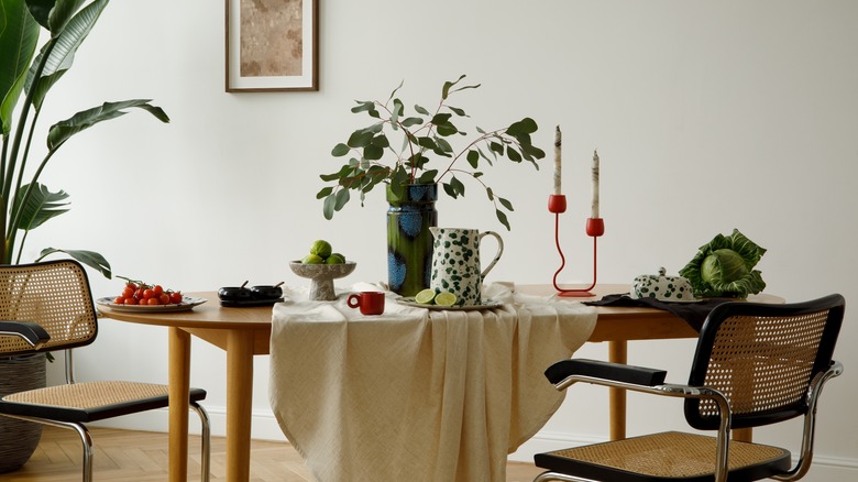 A table setting with rattan chairs with black accents.
