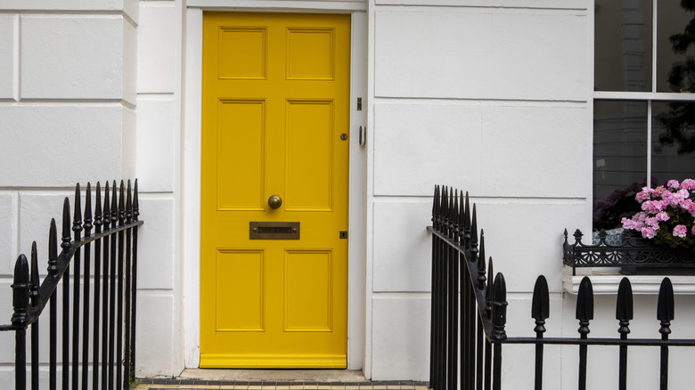 A door with matching unlacquered brass hardware