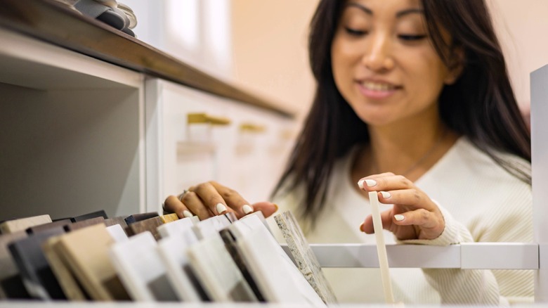 woman sorting through granite countertop samples in drawer