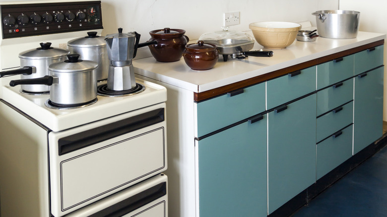 A 1960s kitchen with all the common cookware of the era on display.