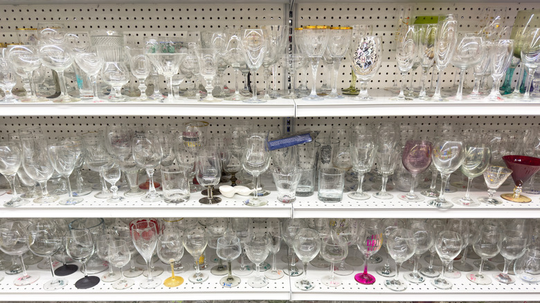 shelves of glass items at a thrift store