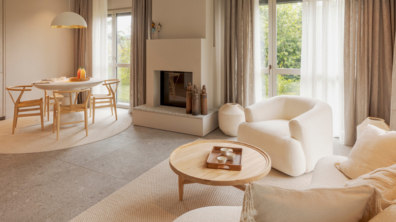 Beige living room with matching sofas and wooden chairs and coffee table