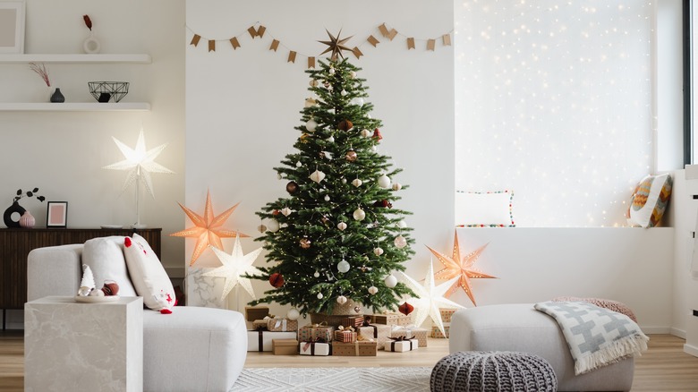 A decorated Christmas tree displaying prominently in a living room