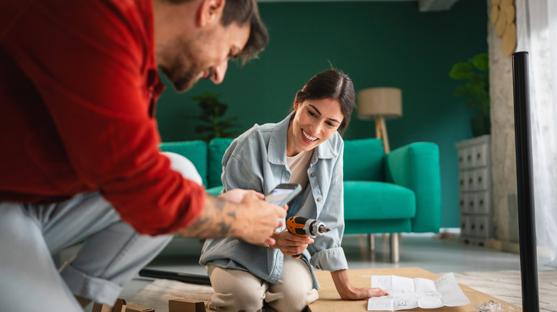 man and woman working on DIY home project together