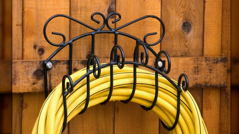 metal hose holder with many hooks to support the hose that can be repurposed