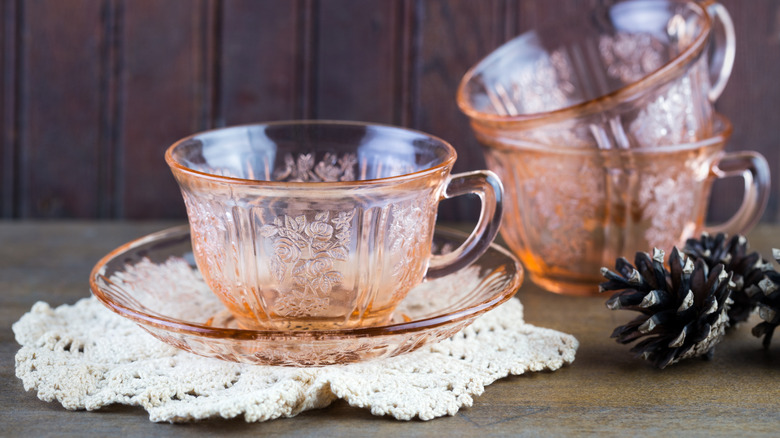 Pink depression era glass tea cups on table