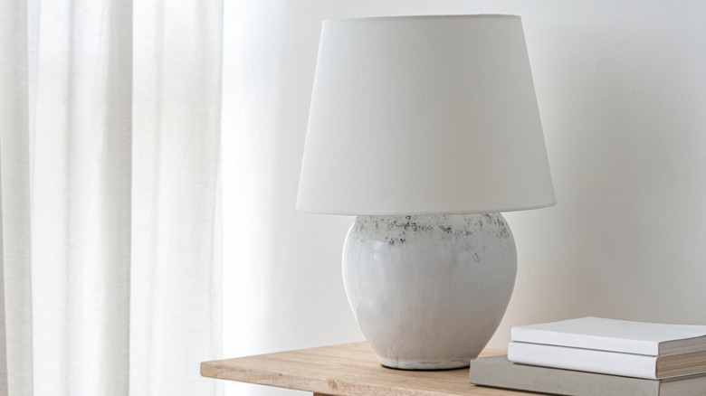 White ceramic lamp on table