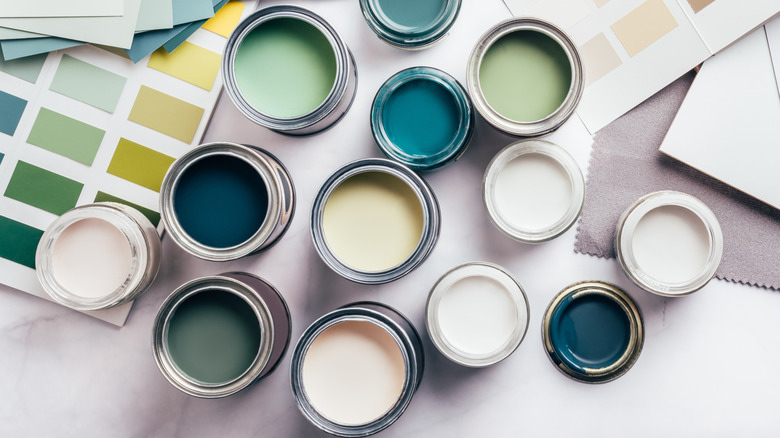 Open paint cans next to paint swatches