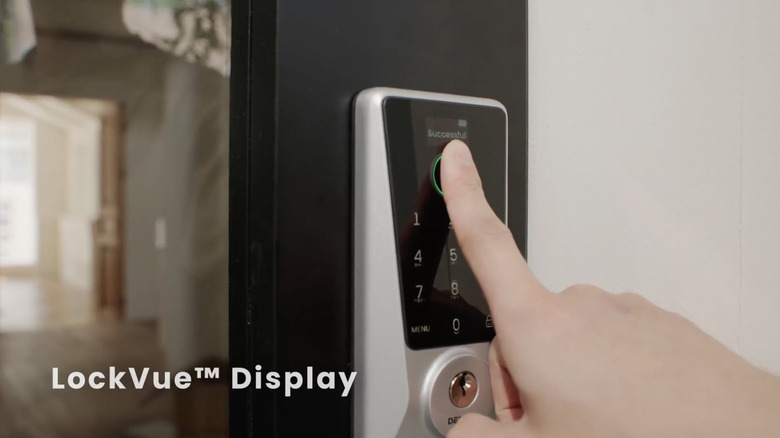 A person presses their fingerprint to a DESLOC D110 Plus Smart Lock