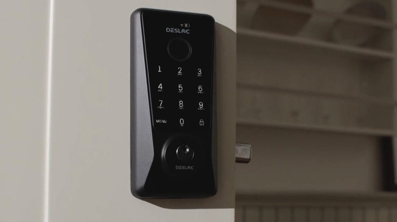 A DESLOC Smart Lock D110 Plus is installed on a white door