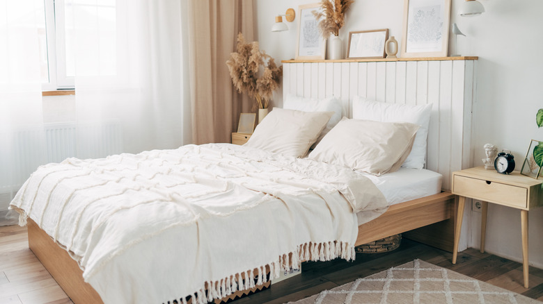 Bed with white and tan sheets