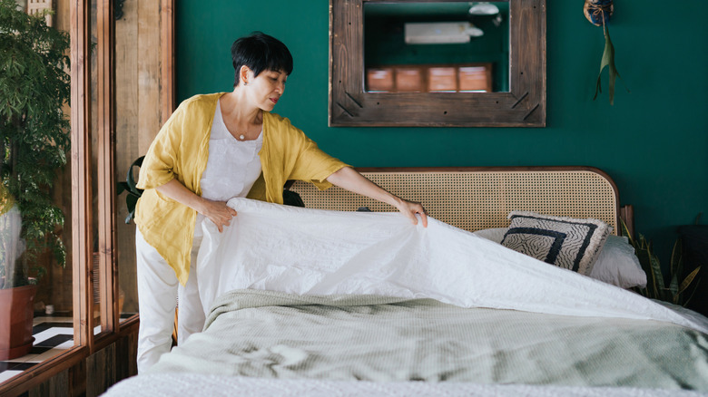 Woman making her bed