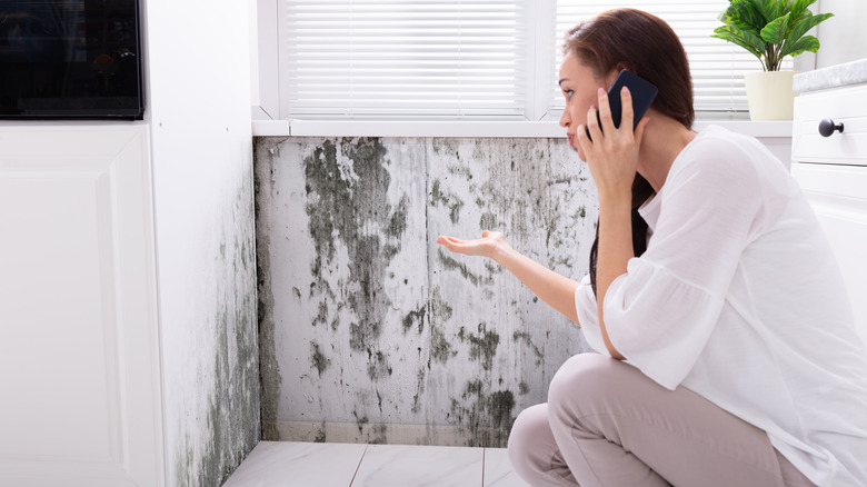 woman finding mold in bathroom