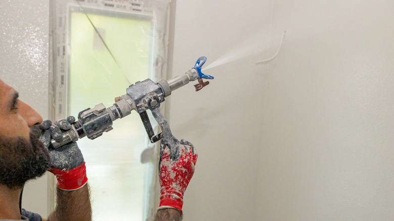 Man applying skim coating to the drywall