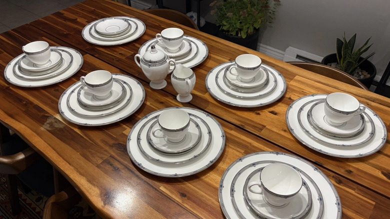 a table of Wedgewood Amherst china laid out with multiple place settings