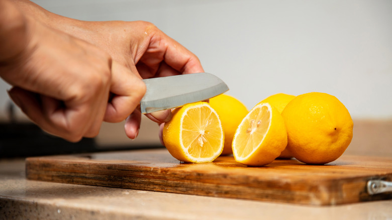 Person cutting lemon