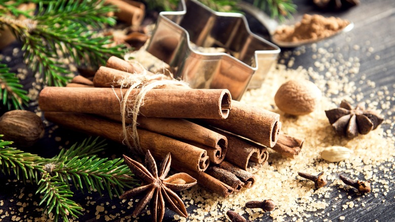 Cinnamon sticks with cookie cutter and greenery