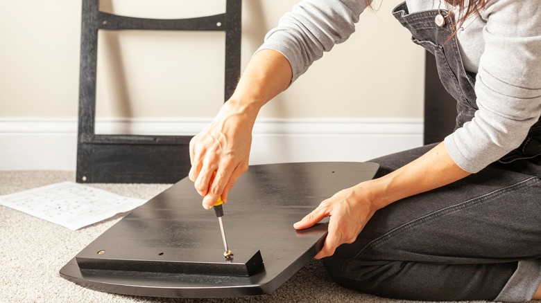 person assembling furniture