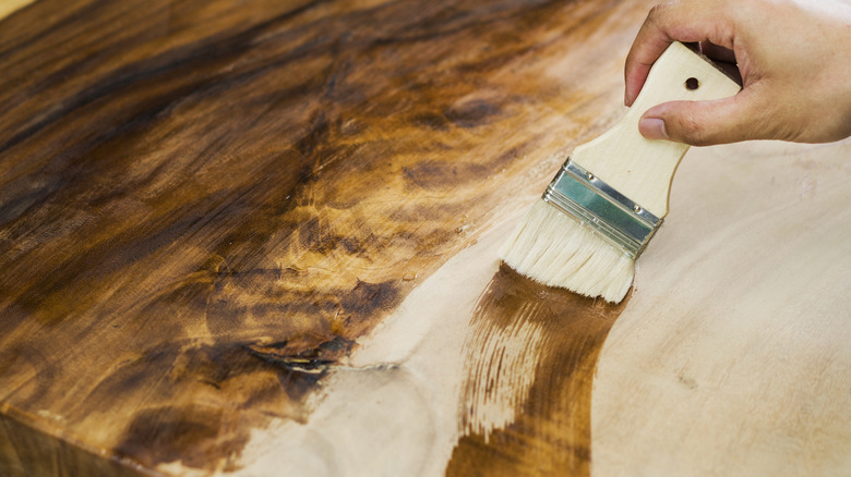 woman painting wooden furniture