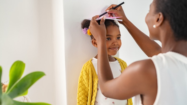 Mom measuring daughter's height