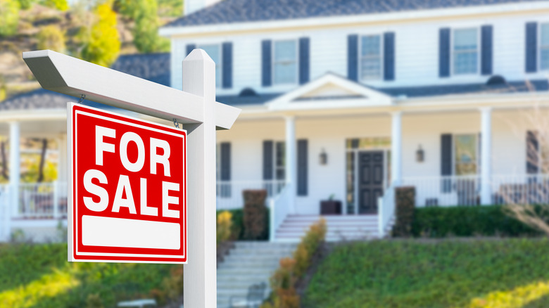 Home with a for sale sign in front yard