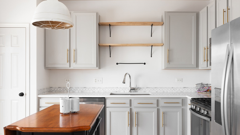 Stylish kitchen with open shelving, empty
