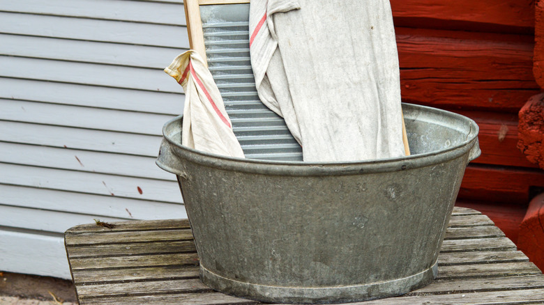 Metal wash tub with washboard and towel