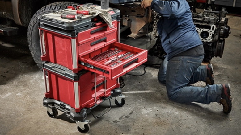 The Milwaukee PACKOUT two-drawer toolbox and the PACKOUT three-drawer tool box stacked on the PACKOUT dolly