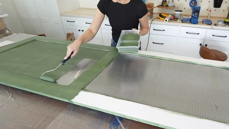 Woman painting the frame