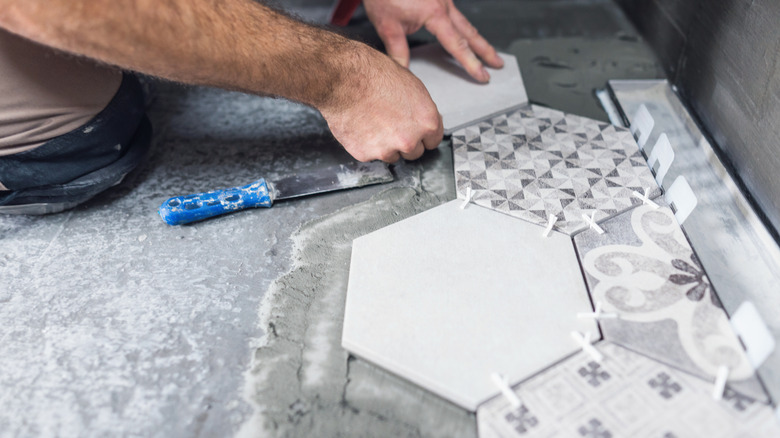 Laying tiles on a bathroom floor
